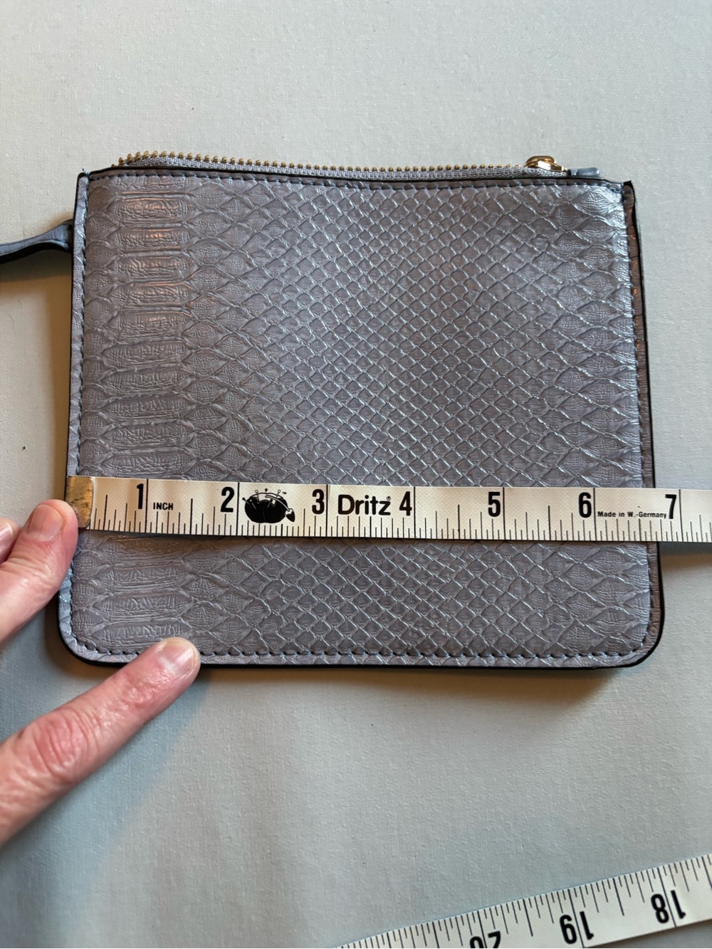 Light blue-gray zippered pouch with attachable fob